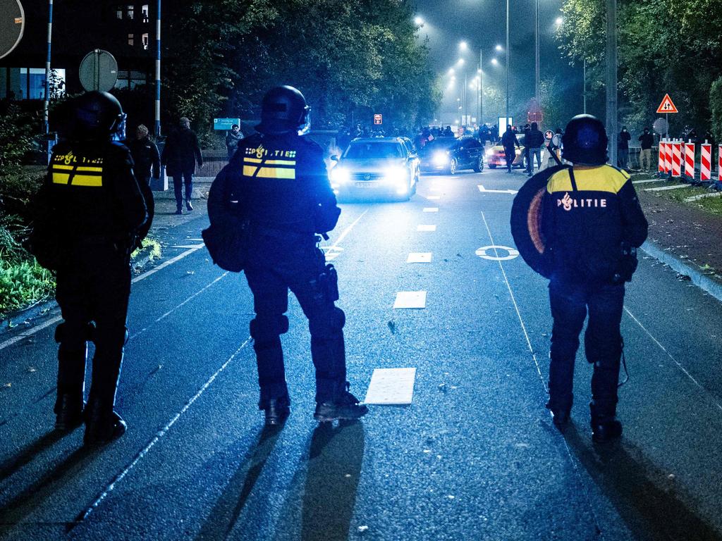 Police officers from the Mobile Unit (ME) secure during a pro-Palestinian demonstration on the sideline of the UEFA Europa League football match between Ajax Amsterdam and Maccabi Tel Aviv, in Amsterdam on November 7, 2024 (Photo by Jeroen Jumelet / ANP / AFP) / Netherlands OUT