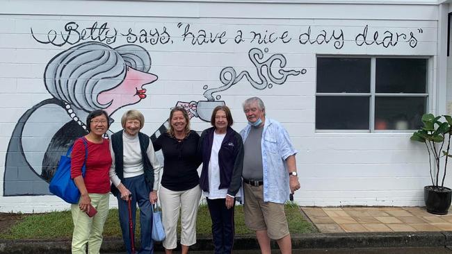 Betty Bromley (second from left) with friends standing in front of a mural made for her. Picture: Supplied