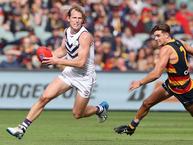 ADELAIDE, AUSTRALIA - APRIL 18: David Mundy of the Dockers runs away from Ben Keays of the Crows during the 2021 AFL Round 05 match between the Adelaide Crows and the Fremantle Dockers at Adelaide Oval on April 18, 2021 in Adelaide, Australia. (Photo by Sarah Reed/AFL Photos via Getty Images)