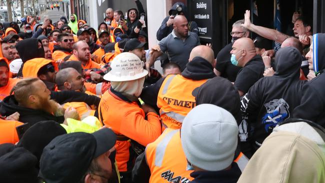 Victorian State Secretary of CFMEU John Setka (hand in air) attempts to talk to construction workers. Picture: David Crosling