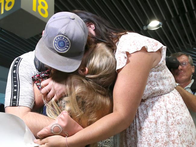 BRISBANE, AUSTRALIA - DECEMBER 01: Matt Jacobi (L) is greeted by his partner Ash and daughter Peyton, as he arrives from Sydney, after four months apart from each other on December 01, 2020 in Brisbane, Australia. Queensland has eased its COVID-19 border restrictions, with travelers from New South Wales and Victoria now permitted to enter the state without having to quarantine. (Photo by Jono Searle/Getty Images)