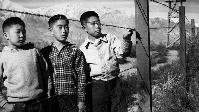 Japanese-American children behind barbed wire in Manzanar internment camp in California during the early 1940s. 