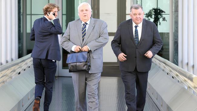 Clive Palmer. middle and Craig Kelly, right, attract attention at Parliament House in Canberra. Picture: NCA NewsWire