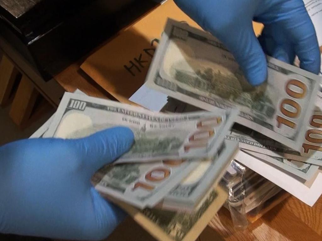 Investigators found wads of cash in various foreign currencies.