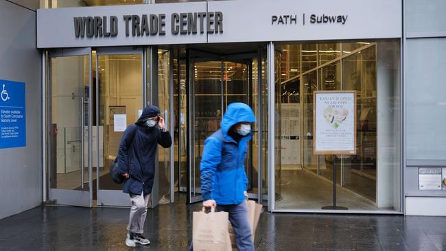 A couple wearing face masks leave a grocery store in lower Manhattan in New York City. Picture: Getty Images