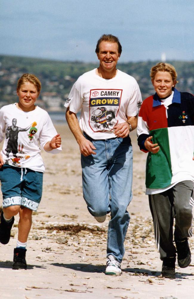 Kane (left, age 10) jogs on the beach with dad Graham Cornes and older brother Chad, 13, in 1993.