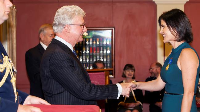 Lydia Gentle receives the Medal of the Order of Australia (OAM) for her services to engineering from former Queensland Governor Paul de Jersey.