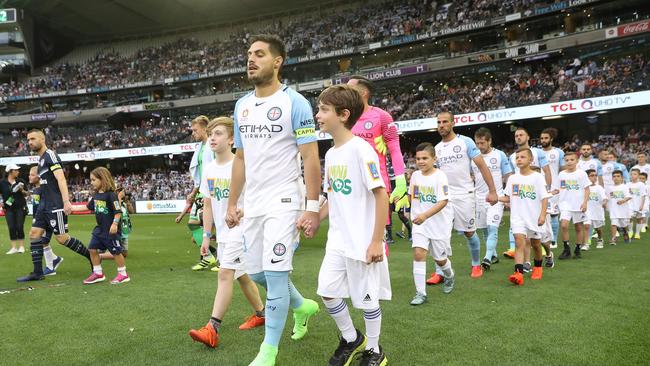 The teams walk out for the round 18 Melbourne Derby.
