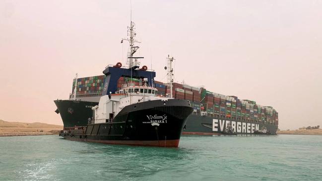 Tugs try to free the Taiwan-owned MV Ever Given as it blocks the Suez Canal. Picture: AFP