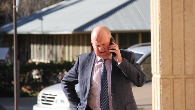 Lawyer for the MacDonnell Regional Council Andrew Harris on the phone out the front of Alice Springs Local Court on July 31, day three of the inquest into death of a toddler who drowned at Kintore pool. Picture: Gera Kazakov