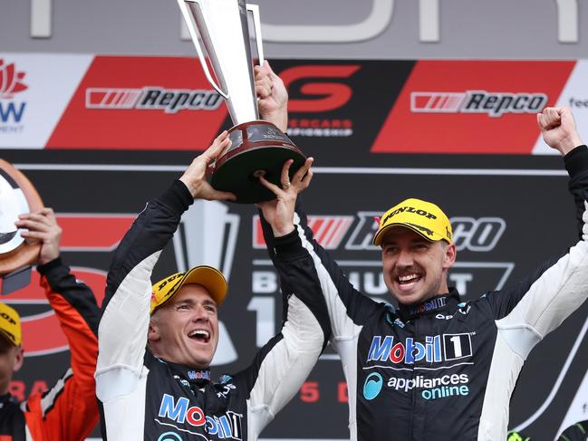 BATHURST, AUSTRALIA - DECEMBER 05: Lee Holdsworth and Chaz Mostert drivers of the #25 Mobil 1 Appliances Online Racing Holden Commodore ZB hold aloft the Peter Brock Trophy after winning the Bathurst 1000 which is part of the 2021 Supercars Championship at Mount Panorama on December 05, 2021 in Bathurst, Australia. (Photo by Brendon Thorne/Getty Images)