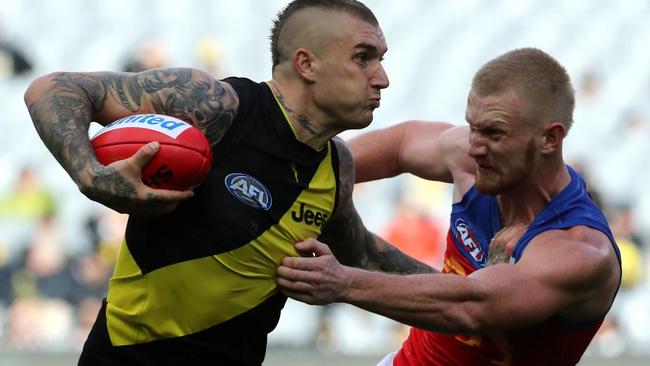 Dustin Martin disposes of Lion Nick Robertson.