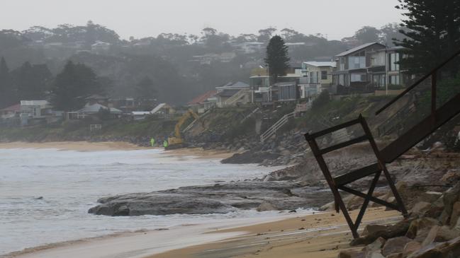 An excavator and workers on site at Wamberal on Tuesday morning, July 28, where emergency works to prevent further erosion appear to be working. Picture: Richard Noone