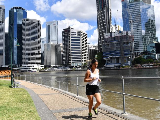 A woman is seen jogging beside the Brisbane River at Kangaroo Point in Brisbane.