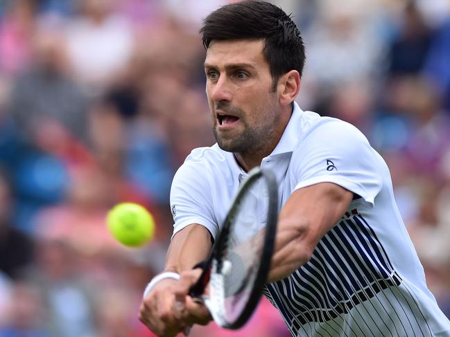 Serbian tennis player and world number four, Novak Djokovic plays a shot during his men's singles round two tennis match against Canadian Vasek Pospisol at the ATP Aegon International tennis tournament in Eastbourne, southern England, on June 28, 2017. / AFP PHOTO / Glyn KIRK