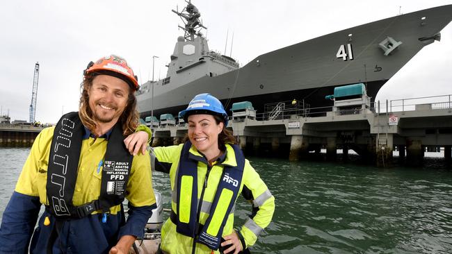 Rigger Trent Sadlier and forklift operator Jade Hills take a waterfront view of airwarfare destroyer HMAS Brisbane which they worked on in Adelaide last year.