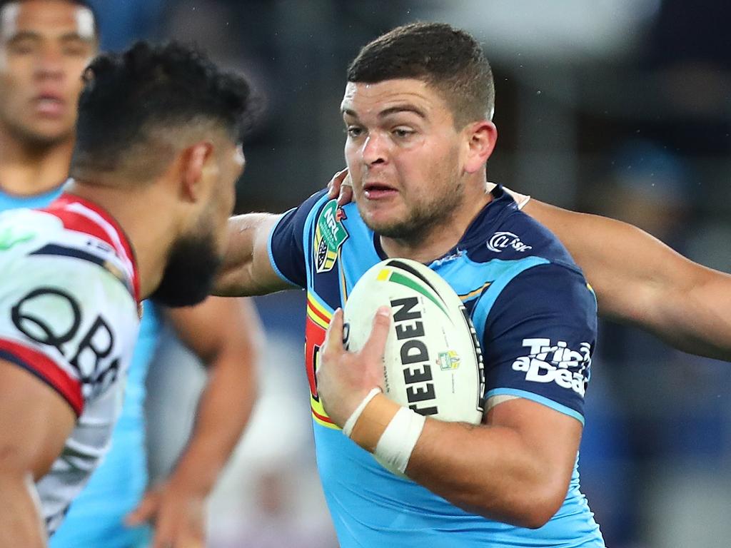 GOLD COAST, AUSTRALIA - JULY 15:  Ash Taylor of the Titans is tackled during the round 18 NRL match between the Gold Coast Titans and the Sydney Roosters at Cbus Super Stadium on July 15, 2018 in Gold Coast, Australia.  (Photo by Chris Hyde/Getty Images)