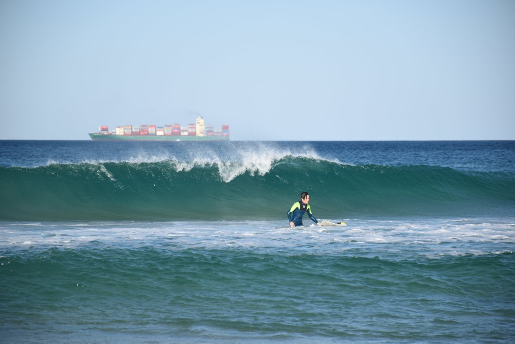 Surfers and bodyboard riders making the most of the waves at Kawana on the weekend. Picture: Mark Furler