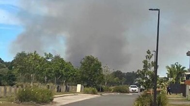 A fire at Little Mountain, pictured from Adelaide Circuit looking towards Baringa State Secondary College, has prompted a school evacuation.