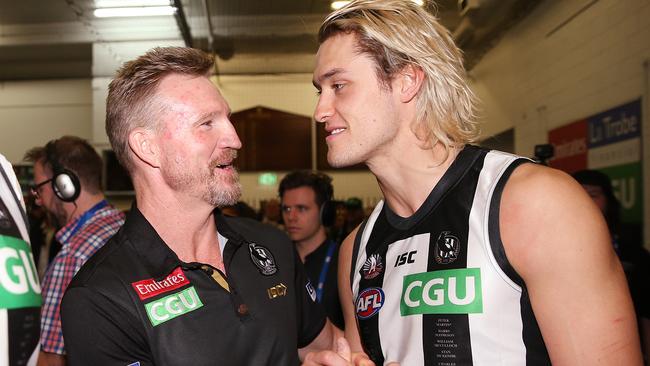 Magpies head coach Nathan Buckley celebrates the win with Darcy Moore 