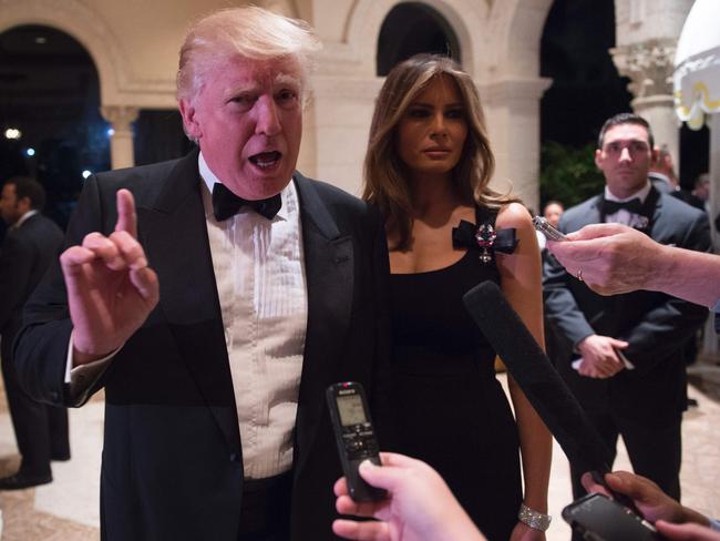 US President-elect Donald Trump answers questions from reporters with wife Melania.