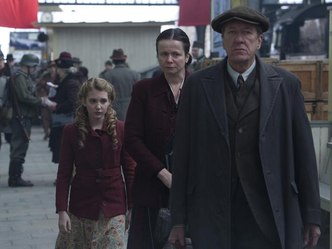 Sophie Nelisse, Emily Watson and Geoffrey Rush in a scene from film The Book Thief.