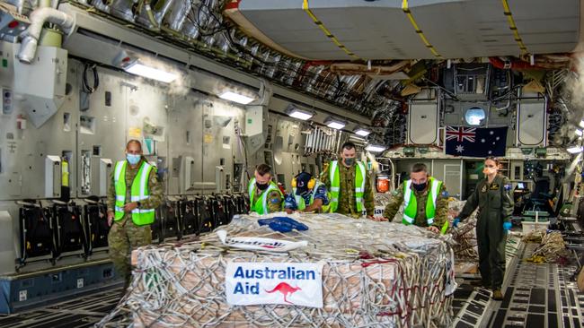 More humanitarian cargo is unloaded from a C-17A with the assistance of PNG based Australian Defence co-operation personnel.