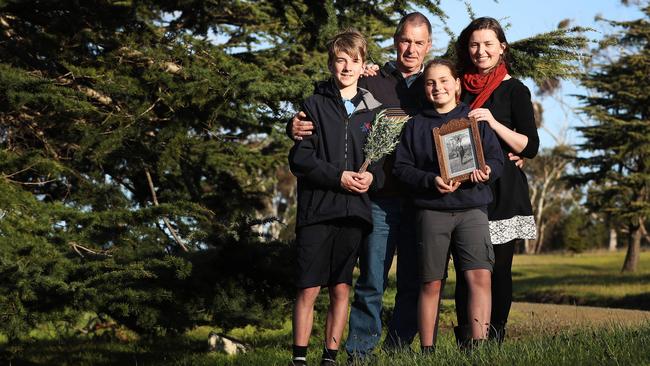 Reuben Pribac, left, Andrew Gates, Minna Pribac (holding a photo of Corporal Phillip Turner) and Rachael Gates at the Soldiers’ Memorial Avenue. Picture: LUKE BOWDEN