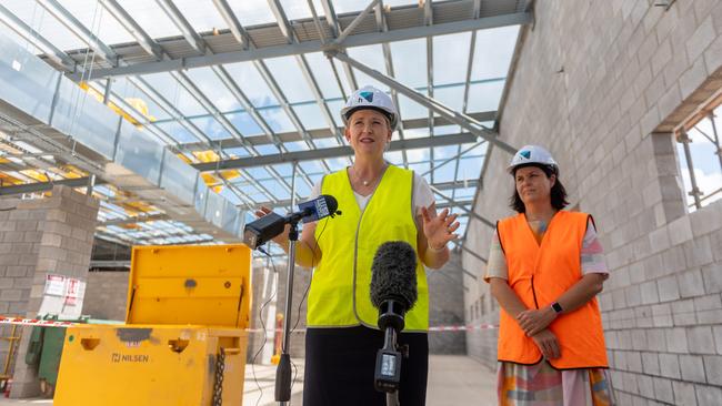 Police Minister Nicole Manison and Nightcliff MLA Natasha Fyles raising the roof at the under-construction 24-hour police station in Nightcliff as part of the John Stokes Redevelopment. Picture: Che Chorley