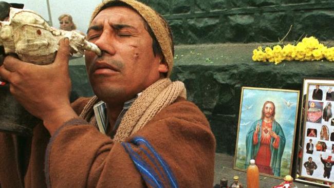 Peruvian Andean soothsayer Erick Caceres, 38, inhales ayahuasca through a shell during a ceremony where soothsayers announce their visions, in the central Lima, Peru district of Rimac, Wednesday, Dec. 30, 1998. Eight of Peru's top soothsayers, known as shamans, offered a ceremony to bless the new year. The soothsayers' predictions are based on visions brought on by the jungle vine ayahuasca, which causes intense hallucinations. (AP Photo/Martin Mejia)