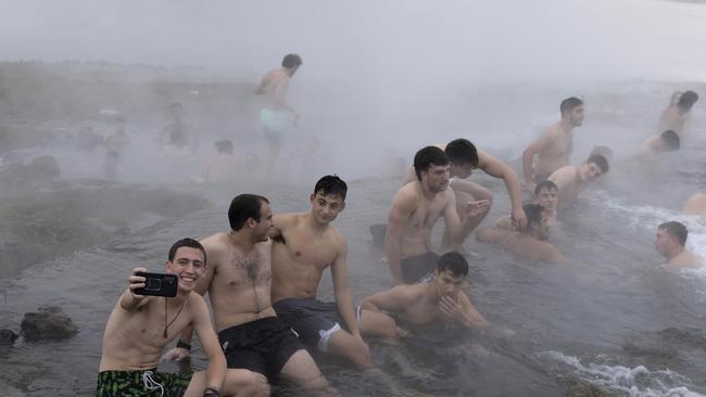 The fighting ended this week, Israeli soldiers and residents enjoy a hot spring in the Golan Height. Picture: Amir Levy/Getty Images