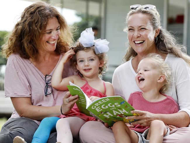 Rebecca Jackes and her daughter Chloe Jackes, 3, (left) with friends Eloise Pillemernt and her daughter Azalea, 3, both from Bondi reading the Dr. Seuss book Green Eggs and Ham at Centennial Park. Six Dr. Seuss books are being pulled because of imagery now considered racist. Picture: Jonathan Ng