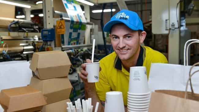 Detpak machine operator Toby Burt with recyclable products, including paper bags, recyclable coffee cups, paper straws and recyclable food packaging. Picture: Brenton Edwards