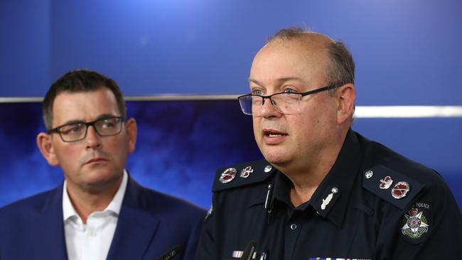 Victoria Police Commissioner Graham Ashton speaks to the media as Premier Daniel Andrews listens on Friday. Picture: Getty Images)