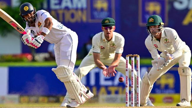 Sri Lanka's Dinesh Chandimal (L) plays a shot during the second day of the first Test cricket match between Sri Lanka and Australia at the Galle International Cricket Stadium in Galle on January 30, 2025. (Photo by Ishara S. KODIKARA / AFP)