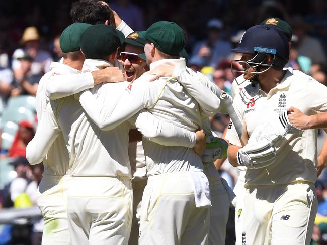 England's batsman Jonny Bairstow (R) walks off after Australia defeated England on the final day of the second Test