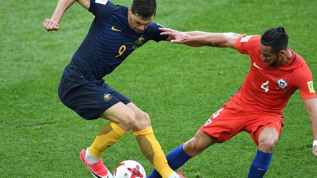 Tomi Juric tries to keep Mauricio Isla at bay.