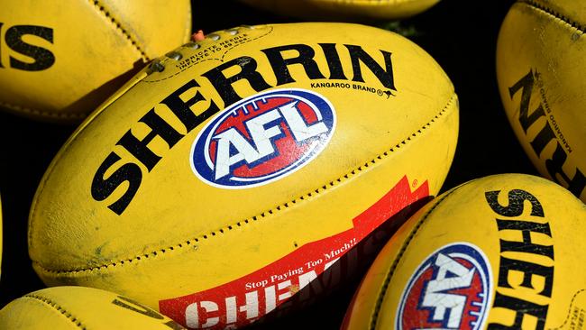 Australian Rules footballs are seen at Arden Street in Melbourne, Thursday, Sept. 10, 2015. (AAP Image/Julian Smith) NO ARCHIVING