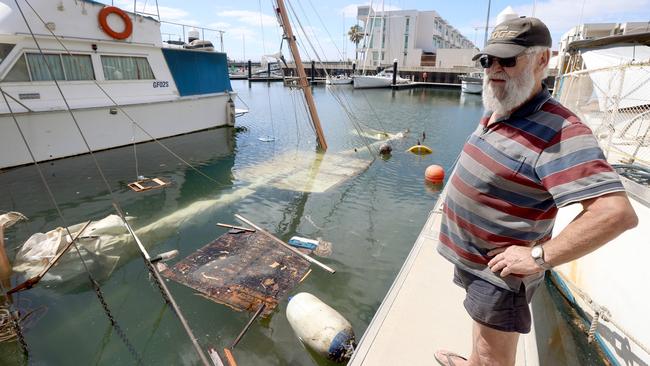 Dieter Czora surveys the damage of his neighbour’s boat that sunk overnight at the New Port marina. Picture: Kelly Barnes