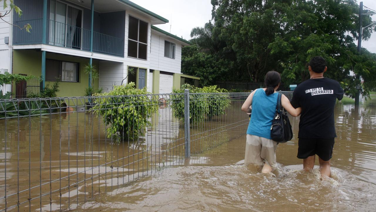 Residents heading home through flood waters on Mill St, Goodna. Photo: Sarah Harvey/ The Queensland Times