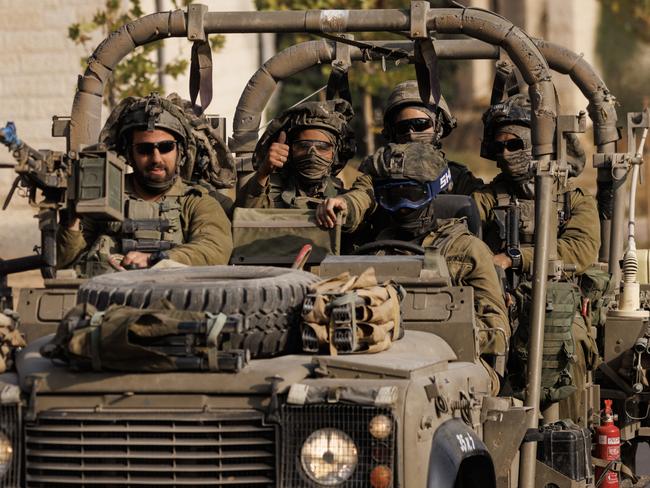 An Israeli soldier gives a thumbs-up gesture as Israeli troops move near the border with Gaza in Sderot, Israel. Picture: Getty Images