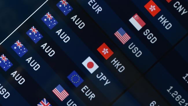 Currency prices are seen on display at a bank on a street in Sydney on October 7, 2014. The Australian dollar hit a four-year-low of 86.43 US cents in New York last week as Australia's economy struggles to transition away from resources-led growth following an unprecedented boom in mining investment that is expected to fall-off sharply over the next year. AFP PHOTO/Peter PARKS