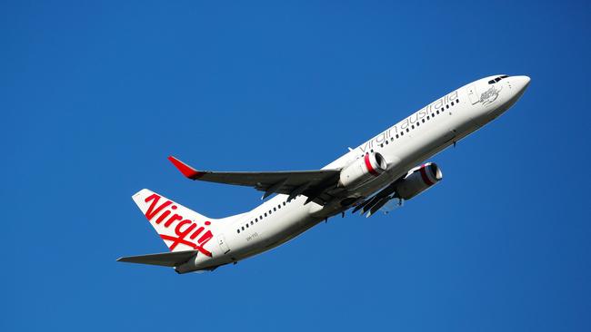 SYDNEY, AUSTRALIA - NewsWire Photos MARCH 24, 2021: An Aerial view of a Virgin Plane taking off from the Domestic Airport in Sydney Australia. Picture: NCA NewsWire / Gaye Gerard.
