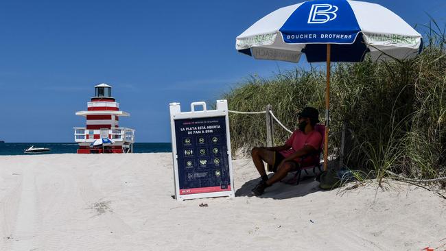 An ocean rescue staff guards the closed beach ahead of the July 4th holiday weekend in Miami Beach. Picture: AFP.