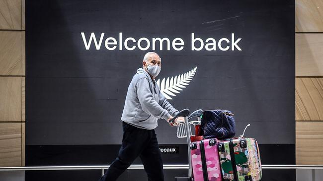 A passenger wearing a face mask arrives from New Zealand at Sydney International Airport on Friday. Picture: AFP