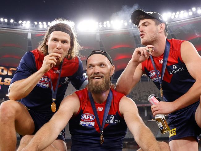 PERTH, AUSTRALIA - SEPTEMBER 25: (L-R) Ed Langdon, Max Gawn and Angus Brayshaw of the Demons celebrate during the 2021 Toyota AFL Grand Final match between the Melbourne Demons and the Western Bulldogs at Optus Stadium on September 25, 2021 in Perth, Australia. (Photo by Michael Willson/AFL Photos via Getty Images)