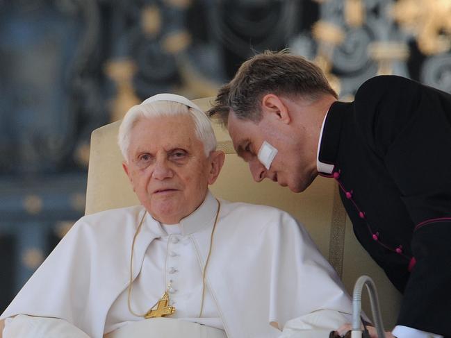 Benedict listens to his personal secretary Georg Gaenswein during his weekly general audience at St Peter's Square in 2010.