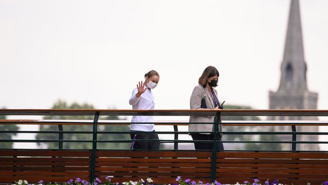 Wimbledon 2021 champion Australia's Ashleigh Barty waves as she walks across the bridge over St Mary's Walk after the women's singles final. Picture: AFP