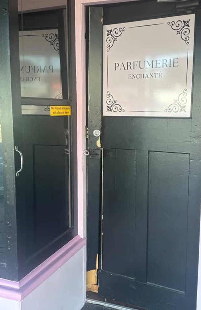 The damaged front door of Parfumerie Enchante. 