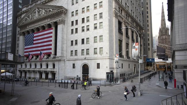 A few people walk on Wall Street in front of the New York Stock Exchange in New York. Picture: AP